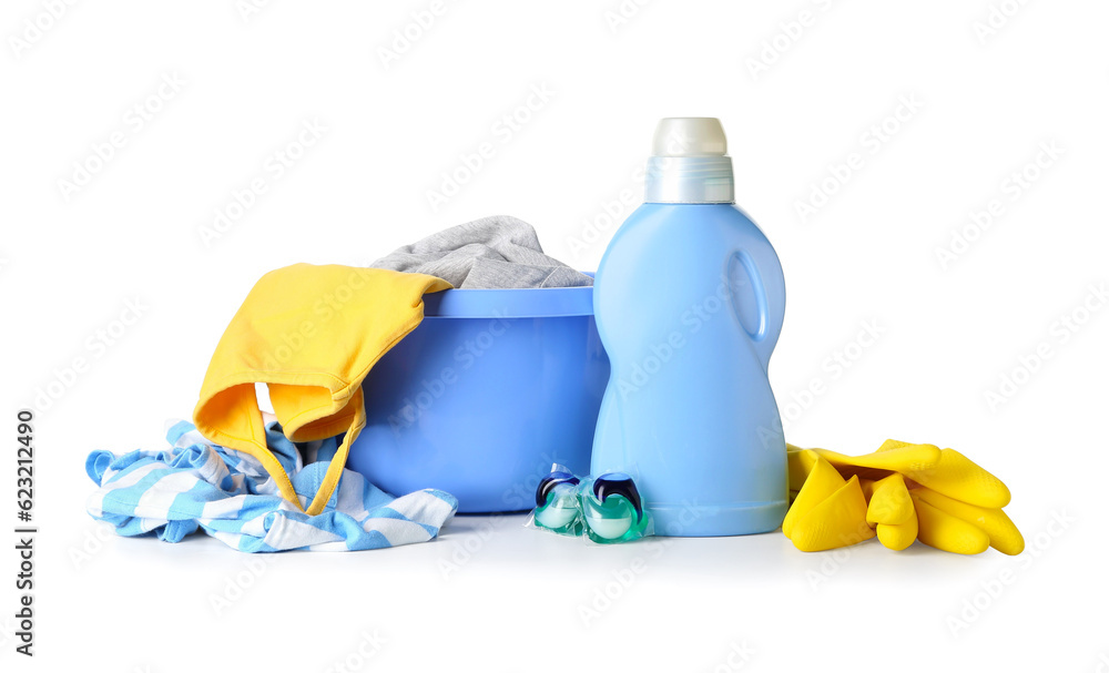 Plastic basin with dirty clothes, laundry detergent and rubber gloves isolated on white background