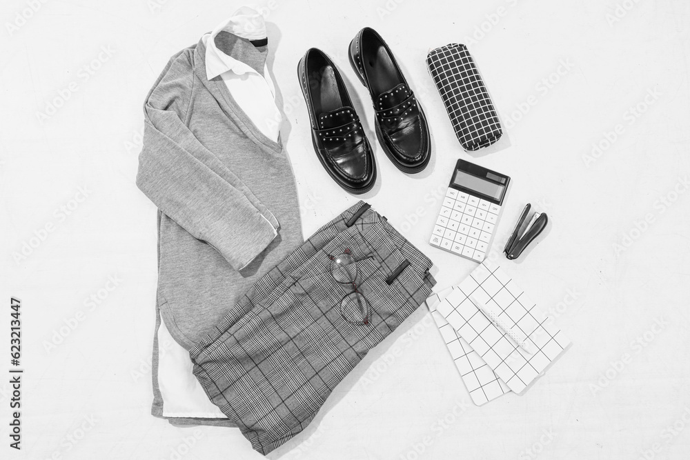 Composition with stylish school uniform, shoes and stationery on white background