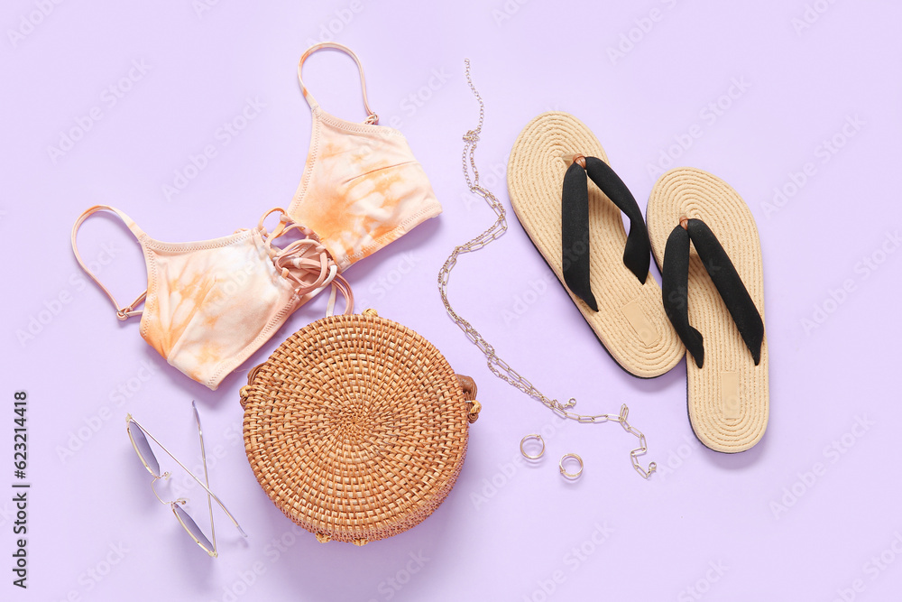 Stylish bikini top, bag, sunglasses, flip-flops and accessories on color background