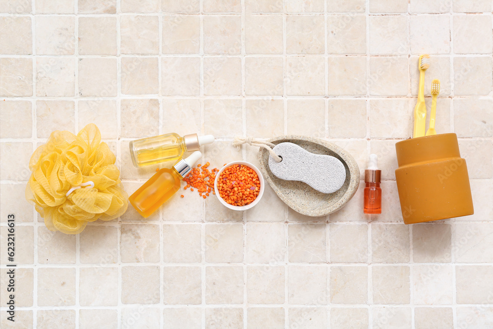 Set of bath accessories, sea salt and cosmetic products on light background