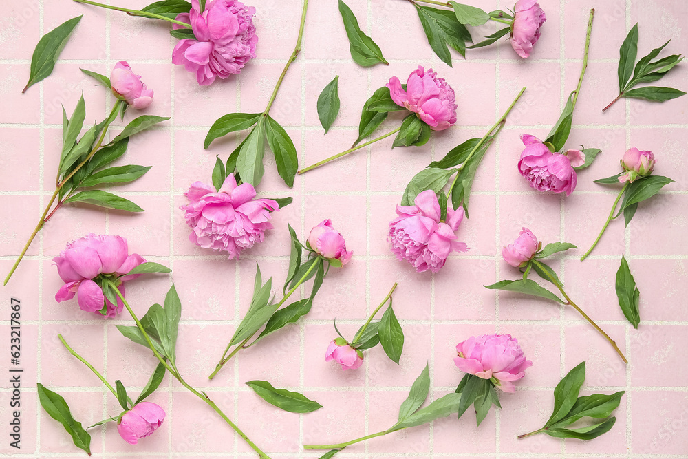 Composition with beautiful peony flowers on color tile background