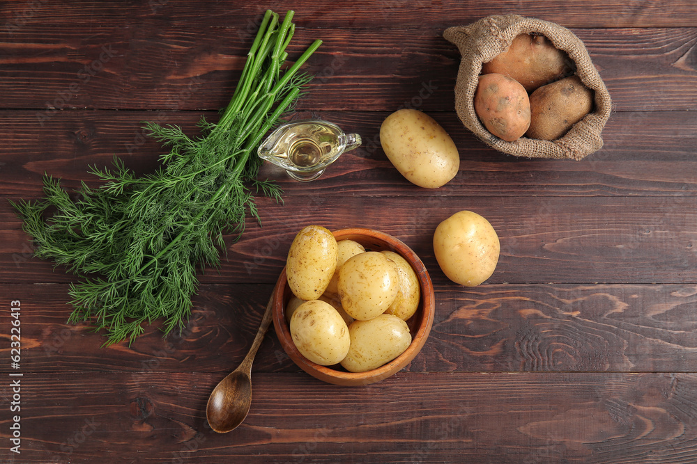 Bowl with sack bag of raw potatoes on wooden background