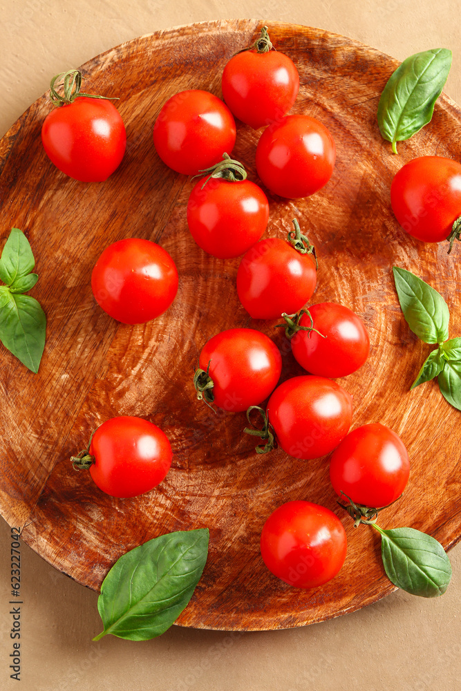 Wooden table with fresh cherry tomatoes and basil on brown table