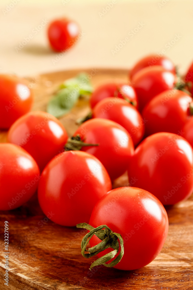 Wooden table with fresh cherry tomatoes and basil on brown table