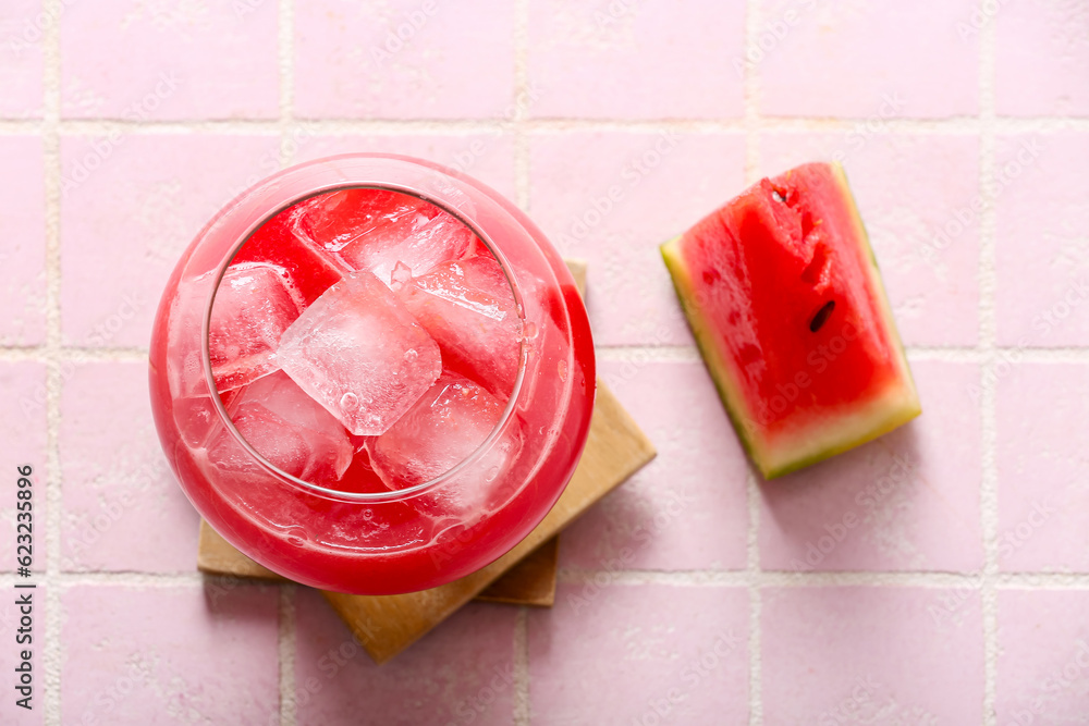 Glass of tasty watermelon fresh on pink tile background