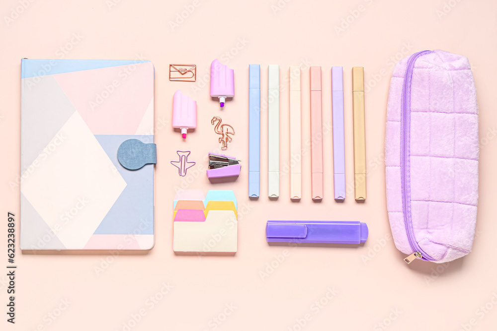 Stylish notebook, pencil case and different school stationery on beige background