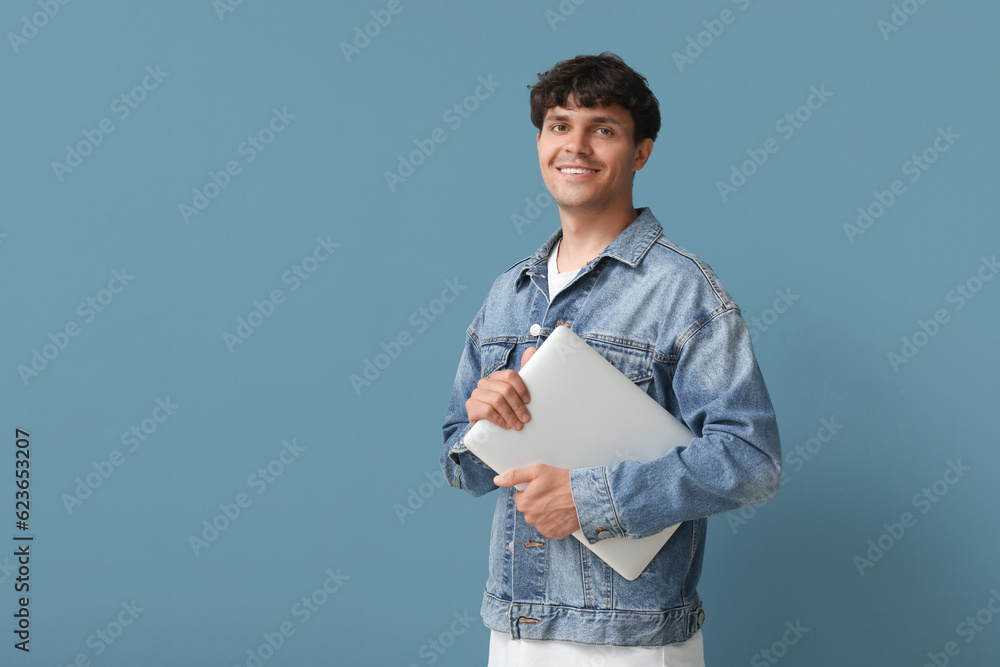 Male programmer with laptop on blue background