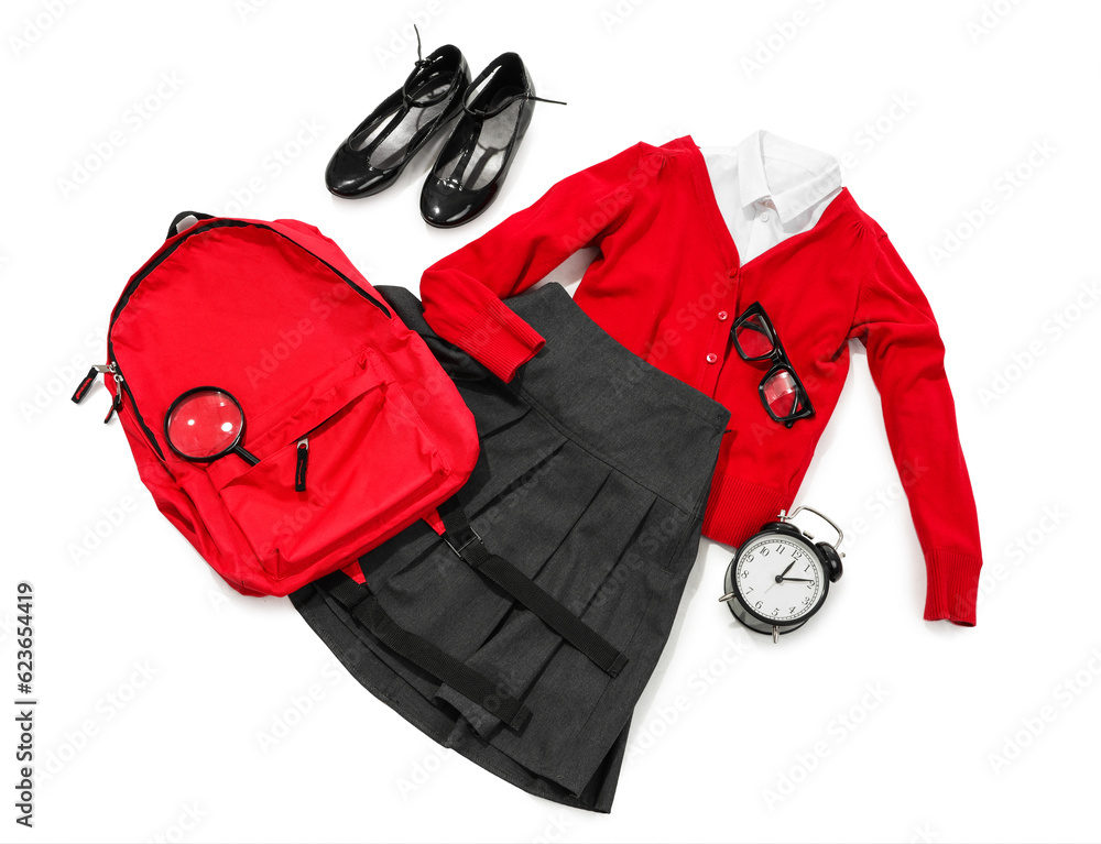 Composition with stylish school uniform, backpack, eyeglasses and alarm clock on white background