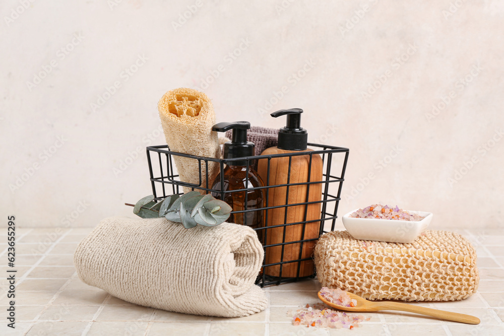 Set of bath supplies and cosmetic products on light tile table