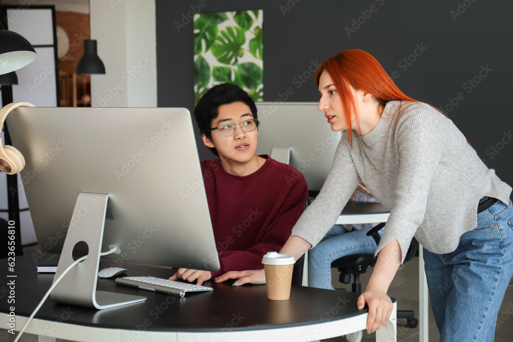 Young programmers working in office