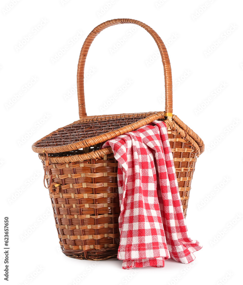 Wicker picnic basket with red checkered napkin on white background