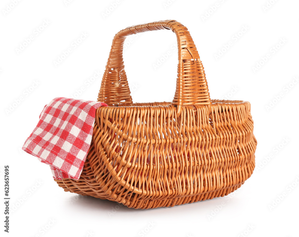 Wicker picnic basket and clean napkin on white background