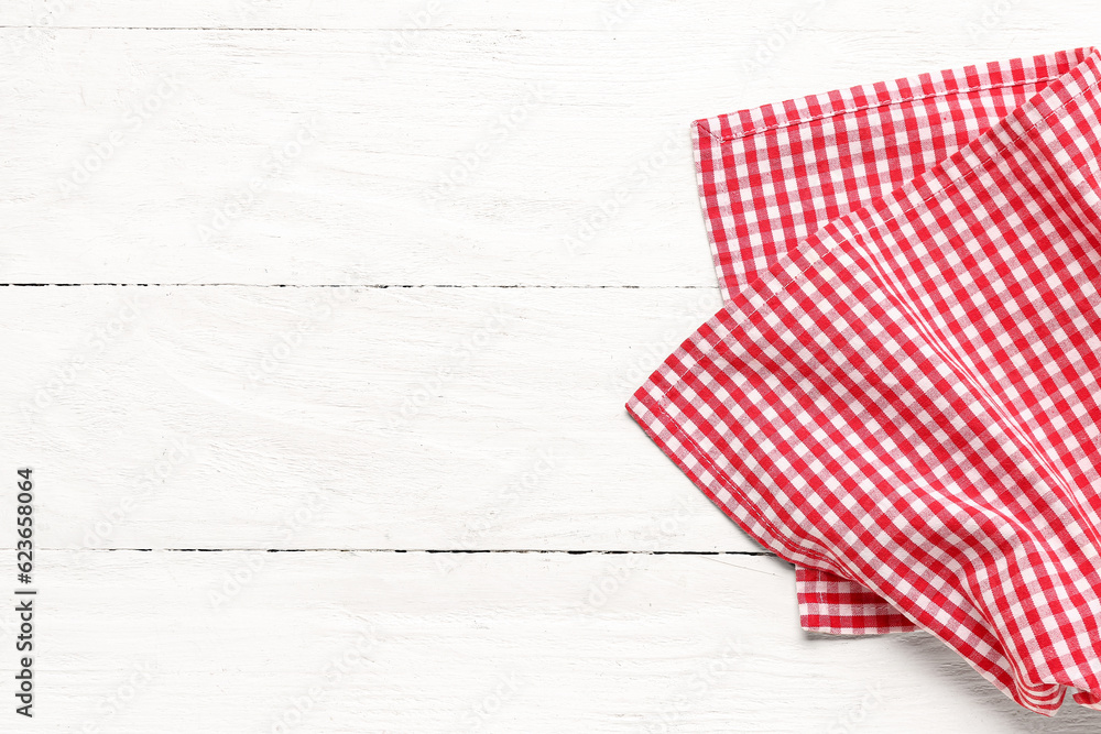 Red checkered napkin on light wooden background