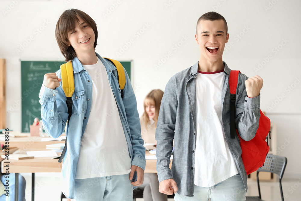 Happy male students in classroom