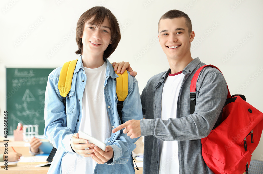 Male students with tablet computer in classroom