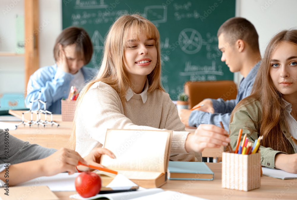 Female students studying at table in classroom