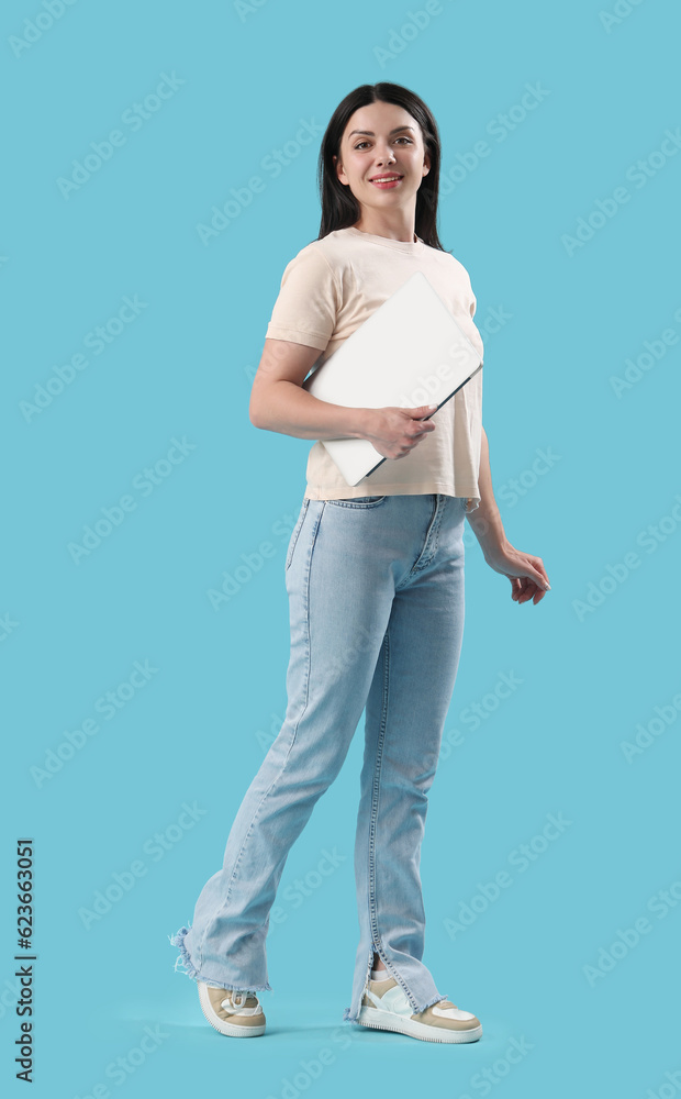 Female programmer with laptop on blue background