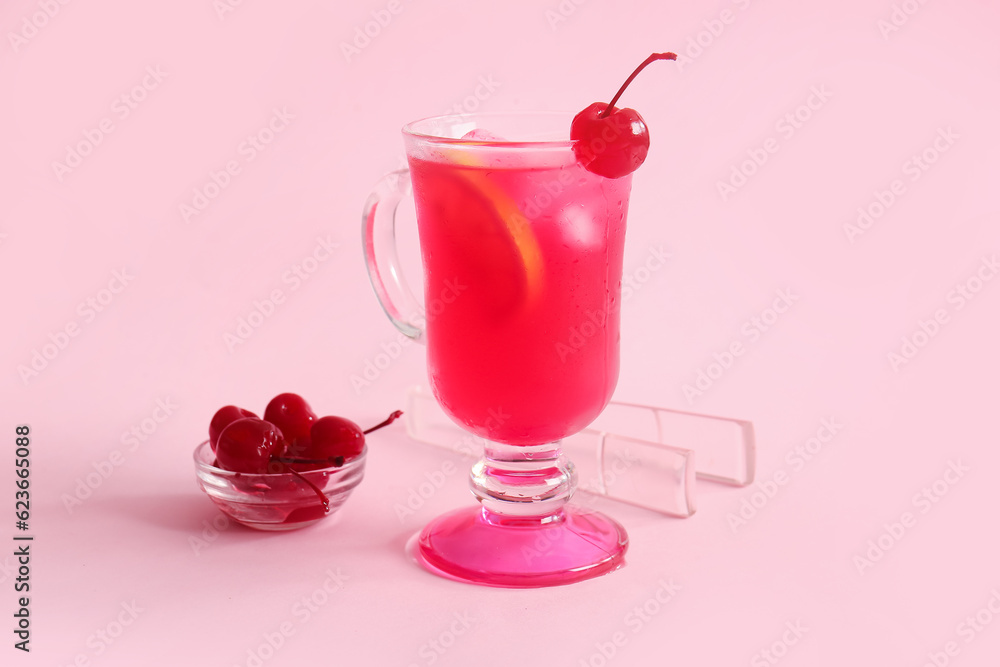 Bowl of tasty maraschino cherries and glass cup with cold cocktail on pink background