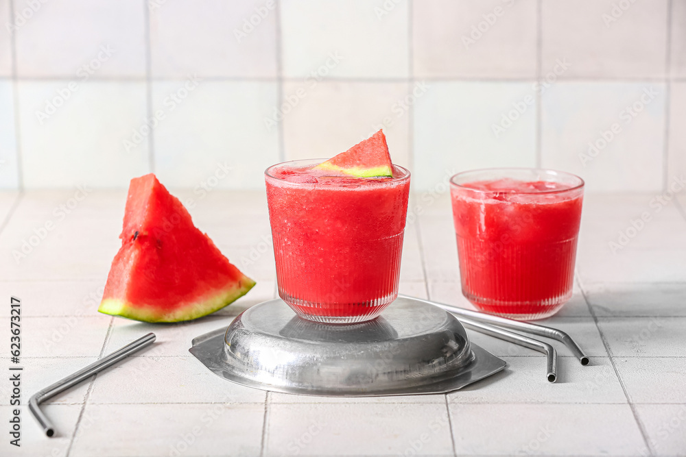 Glasses of tasty watermelon fresh on white tile background