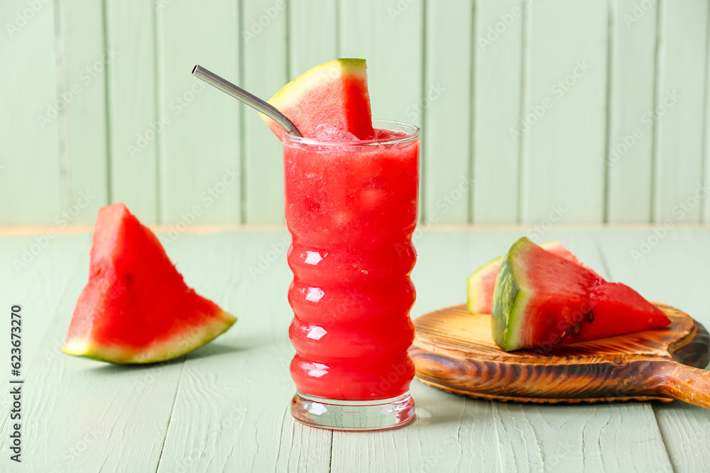 Glass of tasty watermelon fresh on green wooden background