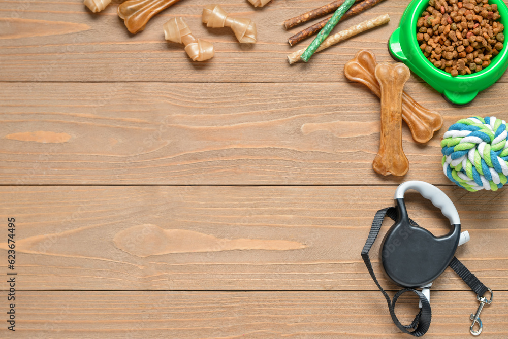 Composition with different dog food and accessories on wooden background