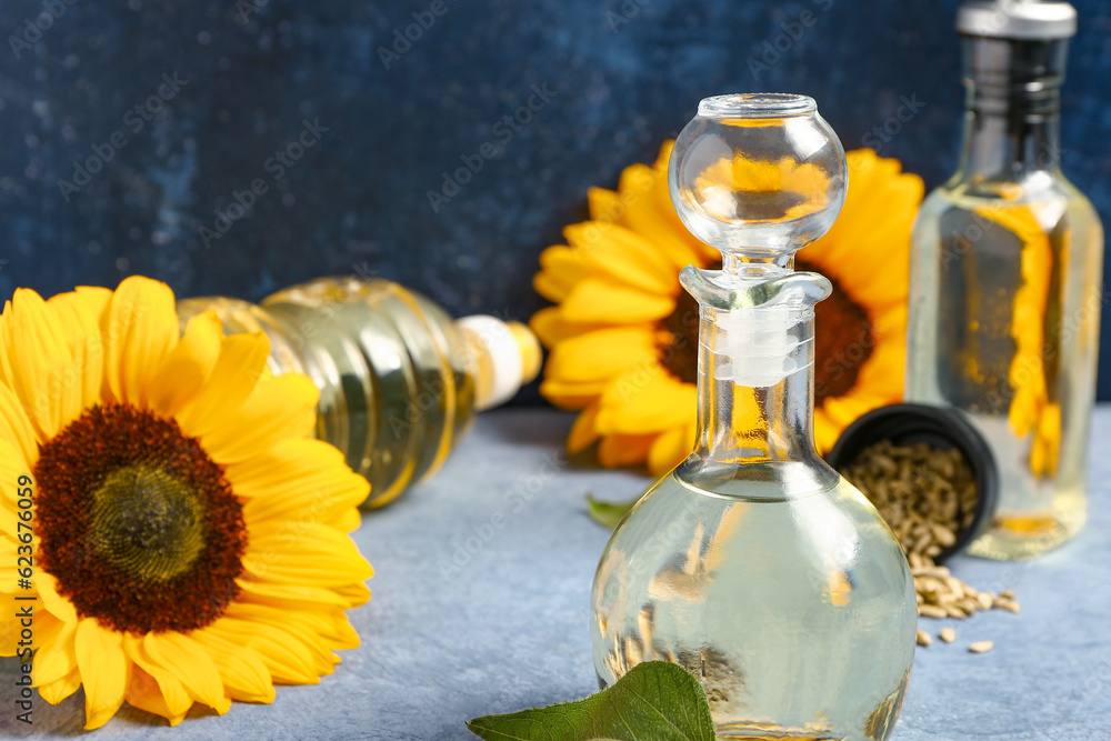 Decanter of sunflower oil on blue background