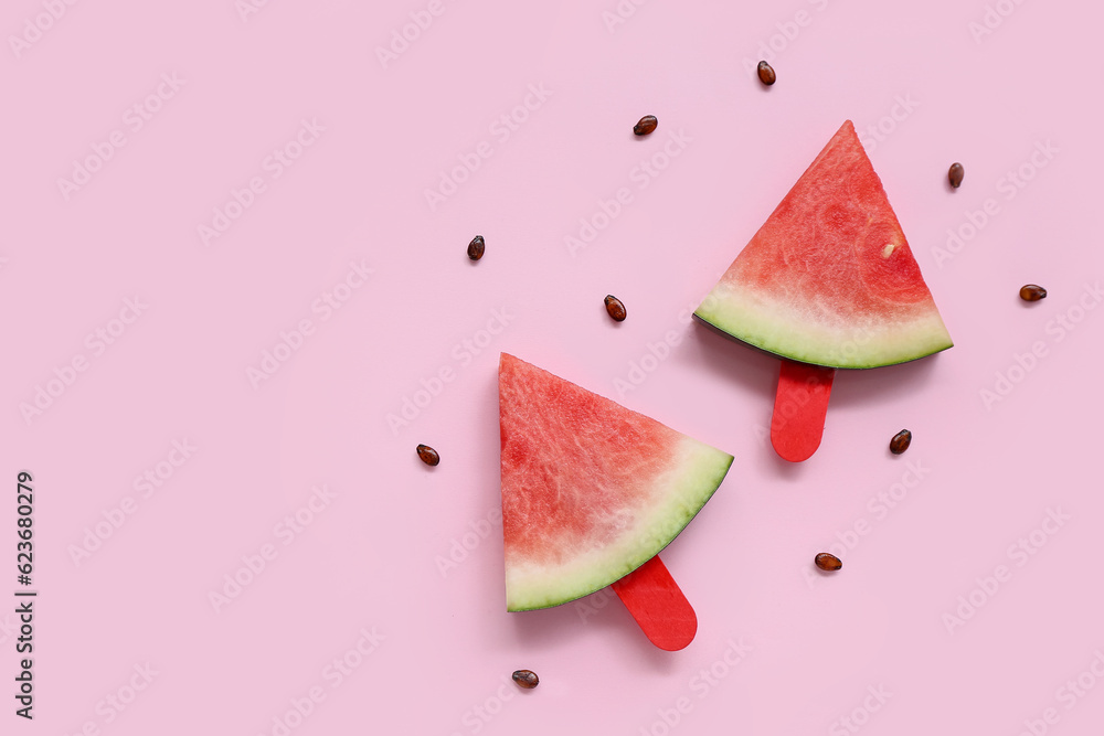 Sweet watermelon sticks and seeds on pink background