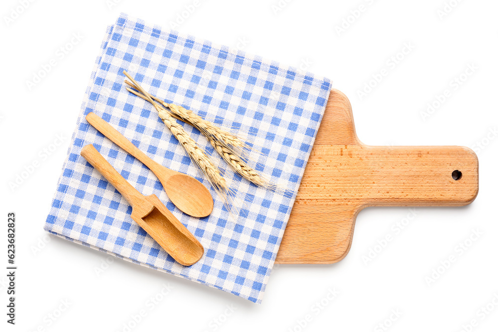 Wooden kitchen utensils and clean napkin isolated on white background