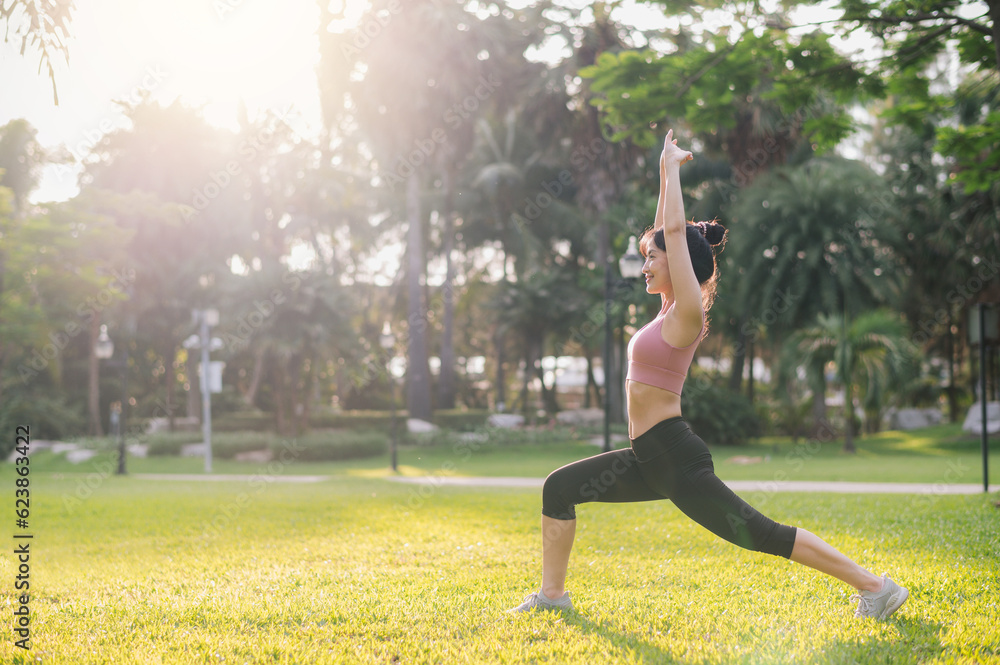 wellness and well-being fit 30s young Asian woman in pink sportswear stretches muscles in park befor