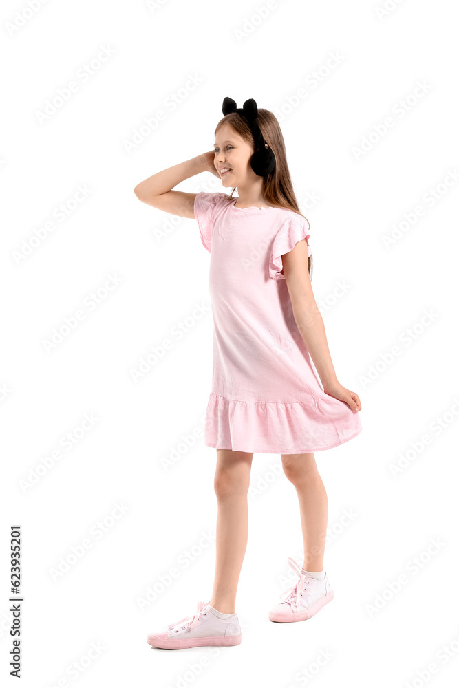 Little girl in cute headphones on white background