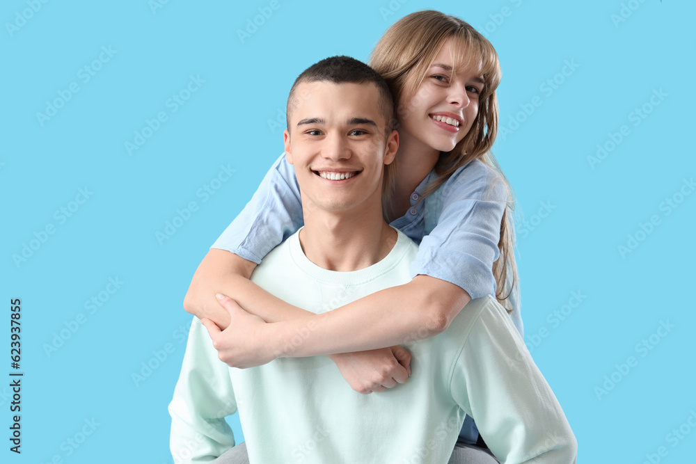 Couple of teenage students on blue background