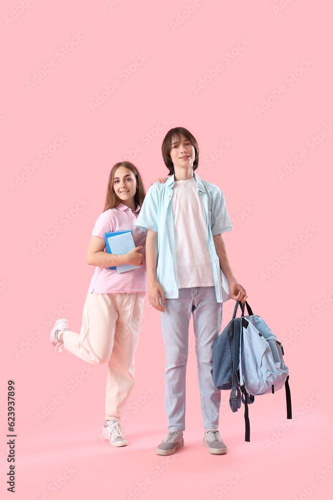 Couple of teenage student on pink background