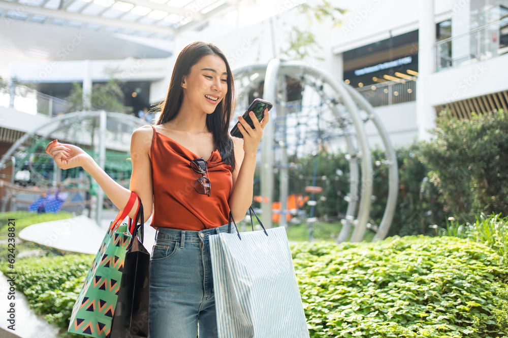 Asian beautiful woman shopping goods outdoor alone in department store. 