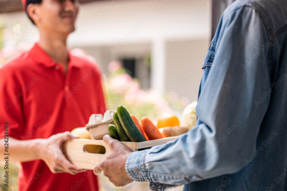 Close up hands of young delivery man delivering package to customer. 