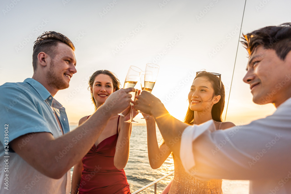 Group of diverse friends drink champagne while having a party in yacht. 