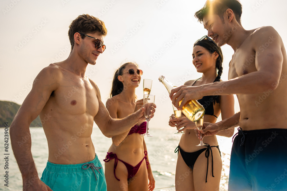 Group of diverse friends drink champagne while having a party in yacht. 