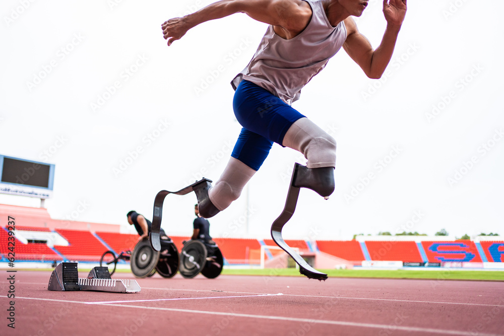 Asian para-athletes disabled with prosthetic blades running at stadium. 