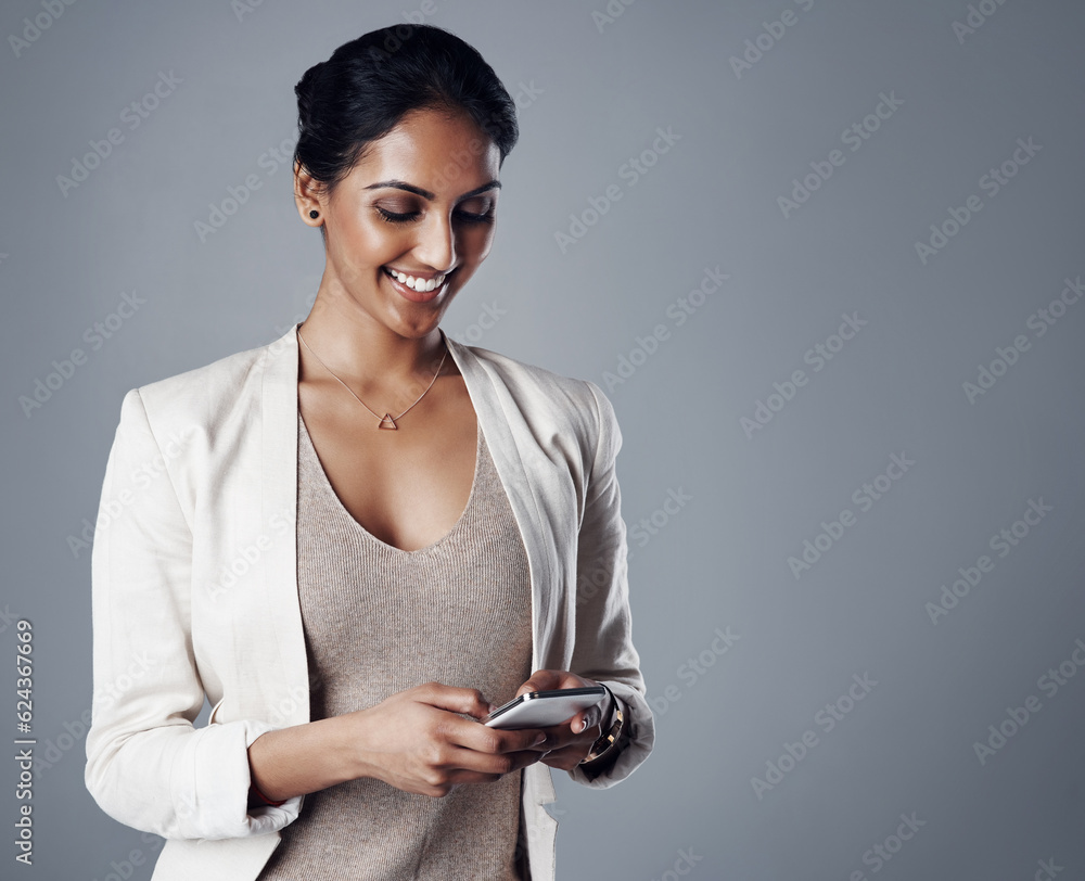 Business, happy and woman with a smartphone, connection and online reading against a grey studio bac