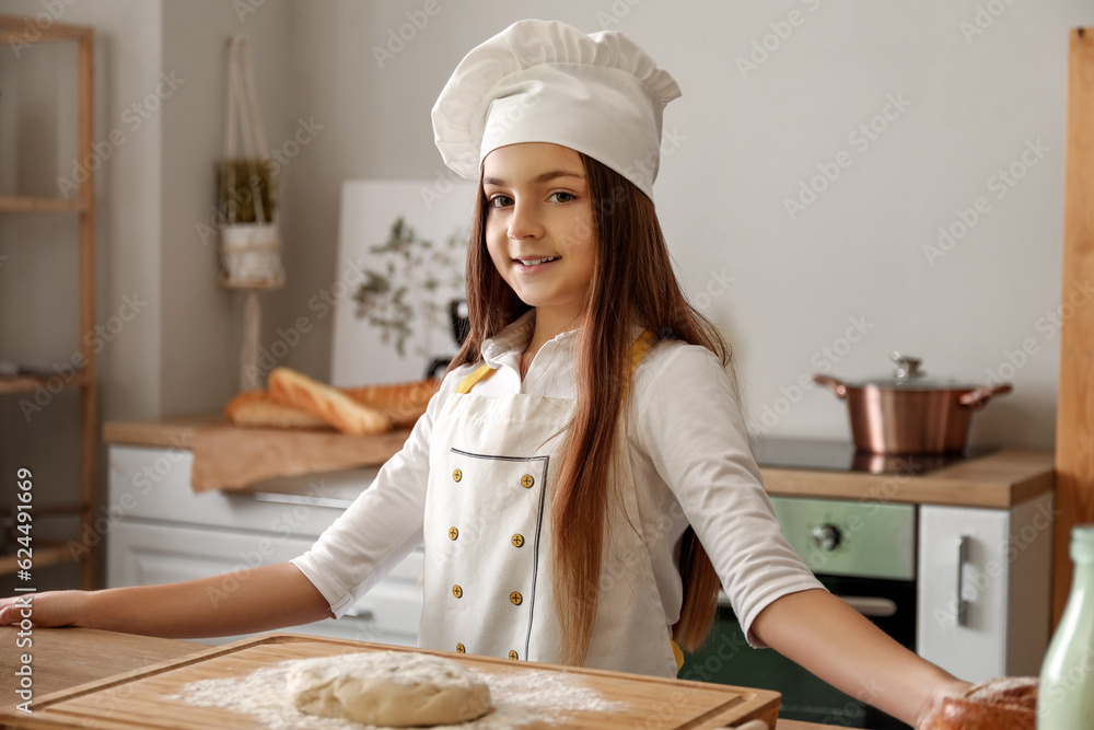 Little baker cooking in kitchen