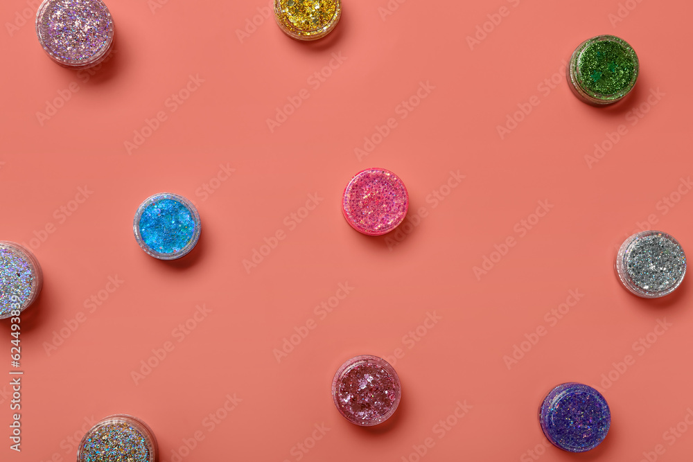 Jars of glitter on pink background