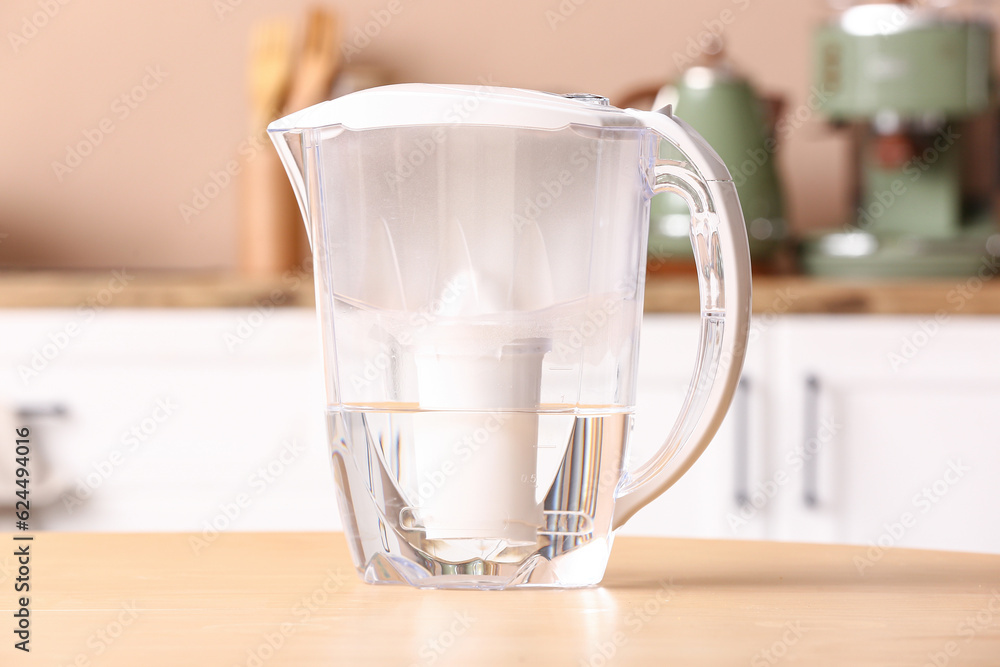 Modern filter jug on table in kitchen