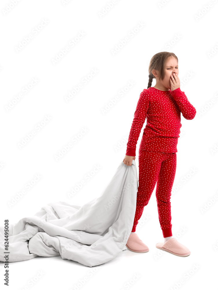 Sleepy little girl in pajamas with soft blanket on white background