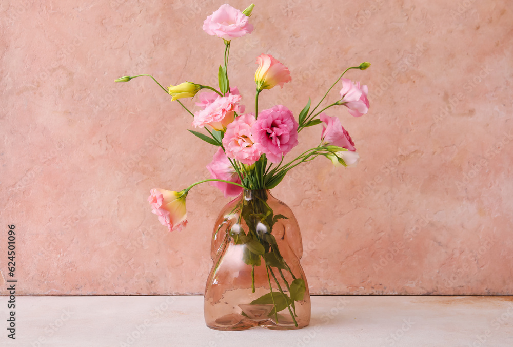 Vase with beautiful pink eustoma flowers on light table