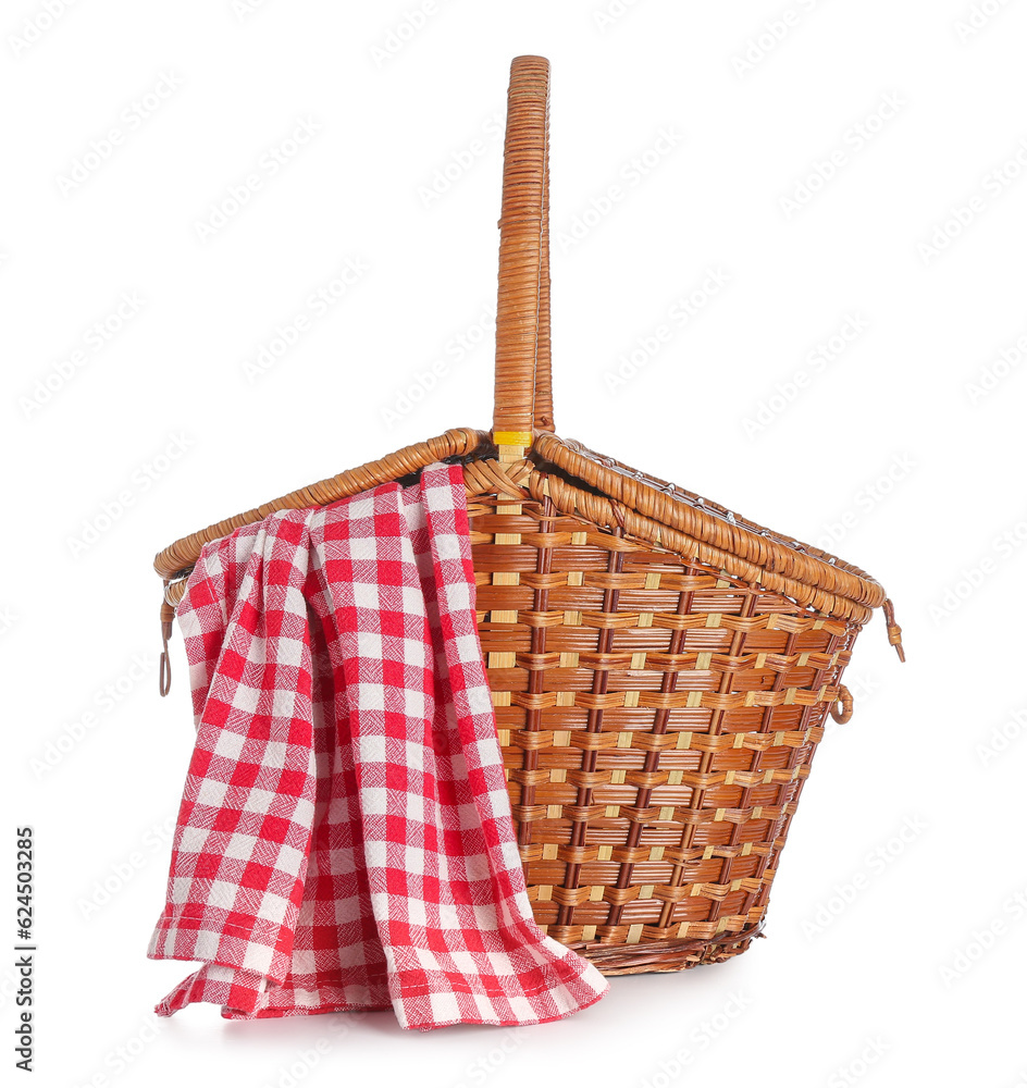 Wicker picnic basket with red checkered napkin on white background