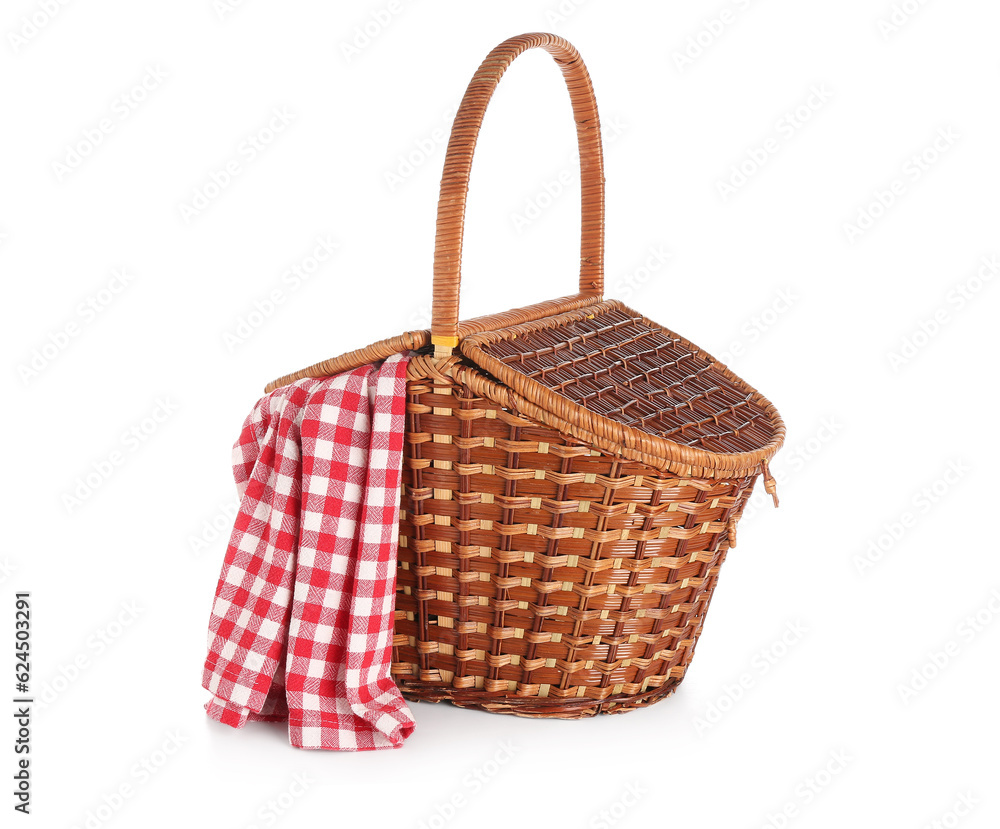 Wicker picnic basket with red checkered napkin on white background