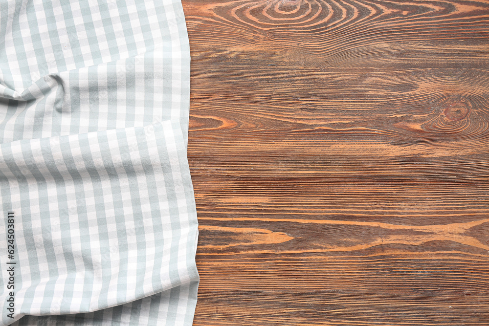 Clean checkered napkin on wooden background