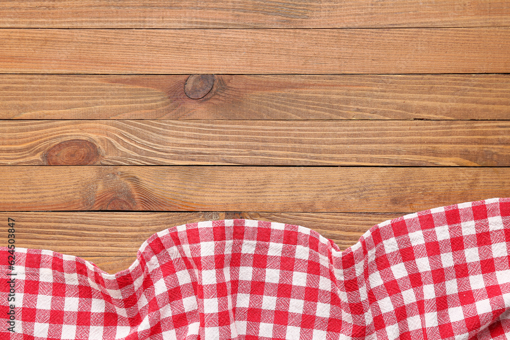 Crumpled red napkin on wooden background, closeup