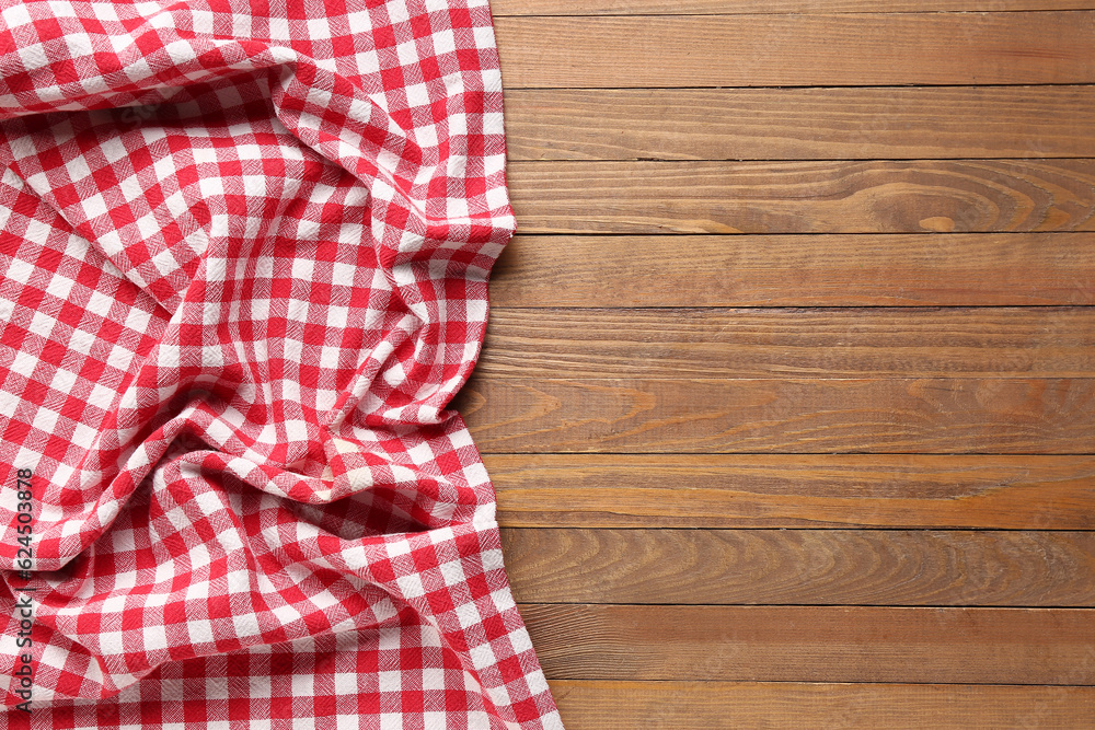 Crumpled red napkin on wooden background