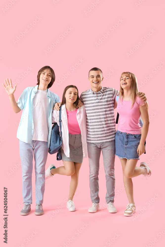 Group of teenage students on pink background