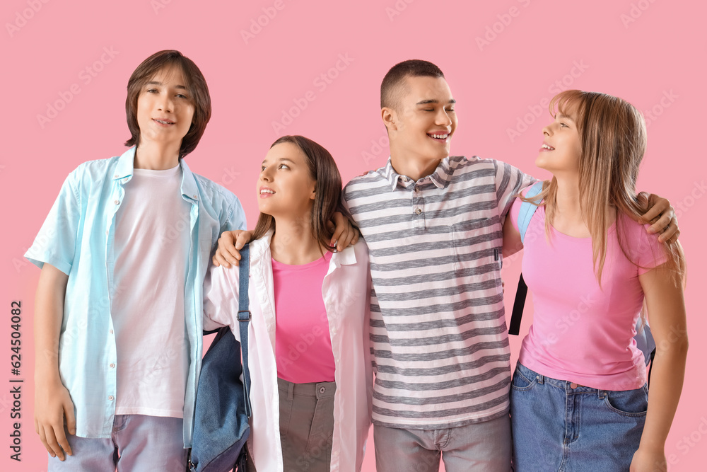 Group of teenage students on pink background